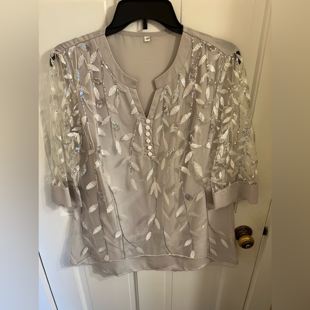 Size medium silver and gray 3/4 arm tunic top. Sheer arms and gray lining.